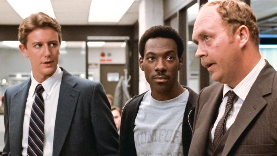 USA. Eddie Murphy, John Ashton and Judge Reinhold  in a scene from the ©Paramount Pictures movie: Beverly Hills Cop (1984). Plot: A freewheeling Detroit cop - Axel Foley , pursuing a murder investigation finds himself dealing with the very different culture of Beverly Hills.  Ref:  LMK110-J6744-170820 Supplied by LMKMEDIA. Editorial Only. Landmark Media is not the copyright owner of these Film or TV stills but provides a service only for recognised Media outlets. pictures@lmkmedia.com