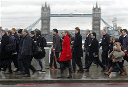 Rush hour workers pass Tower Bridge in the financial district of the City of London January 29, 2013. REUTERS/Luke Macgregor