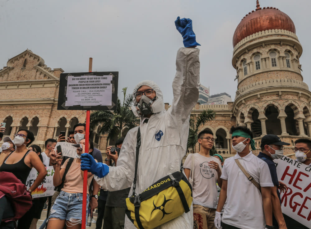 Protesters march and hold placards as they attend the Global Climate Strike in Kuala Lumpur, September 21, 2019. — Picture by Firdaus Latif