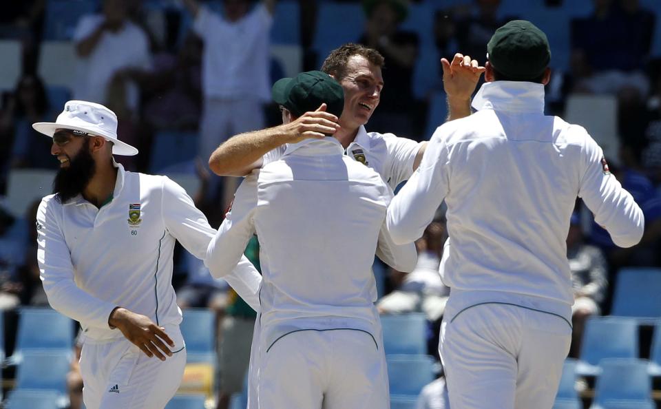 South Africa's Ryan McLaren (C) celebrates with teammates the dismissal of Australia's Alex Doolan who was caught out by Robin Peterson during the first day of their cricket test match in Centurion February 12, 2014.