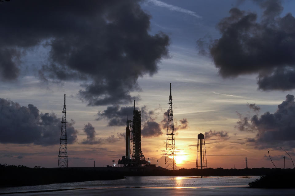 The NASA Artemis rocket with the Orion spacecraft aboard is seen on pad 39B during sunset at the Kennedy Space Center, Monday, June 27, 2022, in Cape Canaveral, Fla. The rocket will roll back to the Vehicle Assembly Building later this week for further tests before a date for an unmanned mission to the moon is set. (AP Photo/John Raoux)
