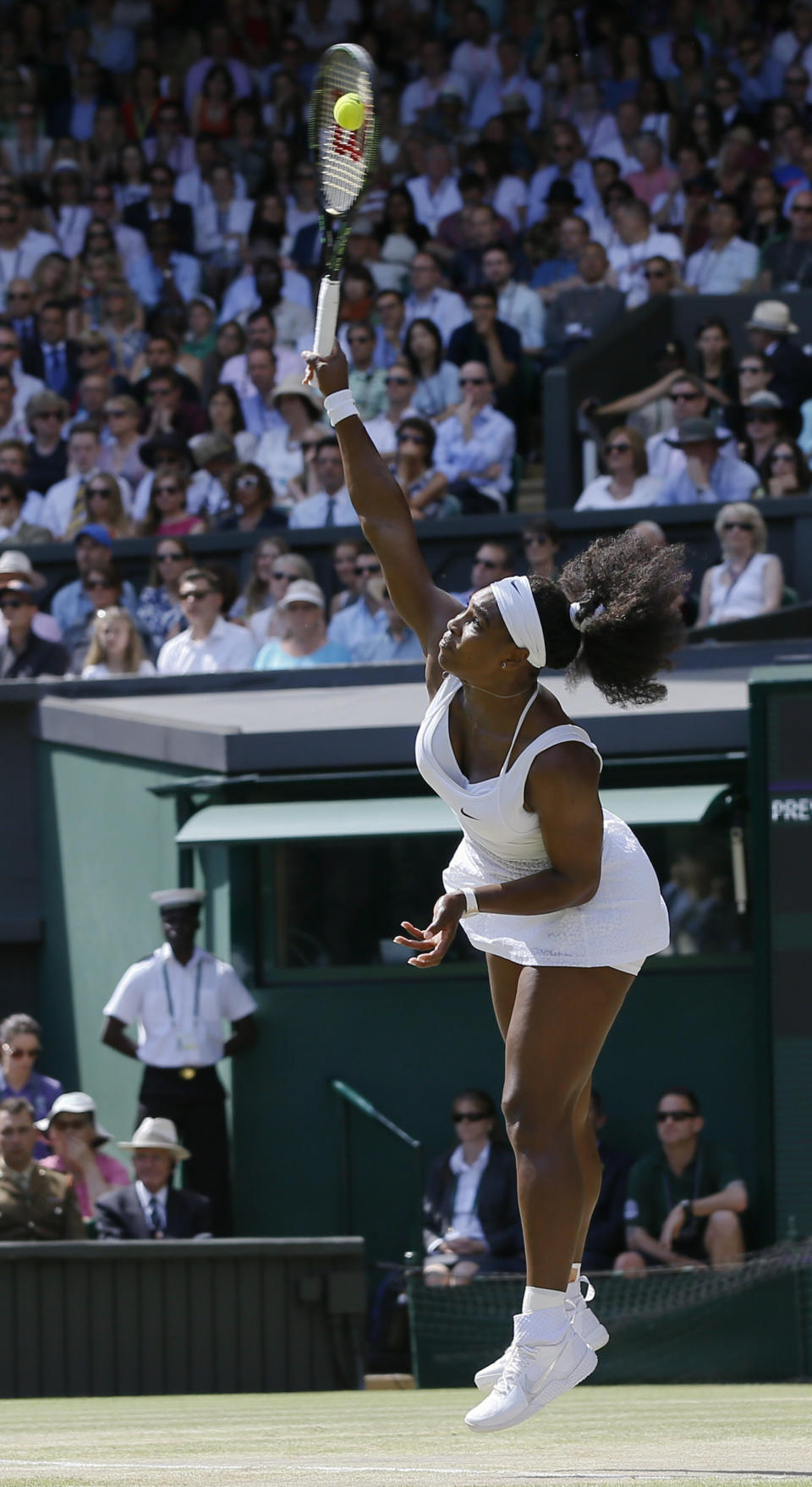 Serena Williams of the United States serves to Garbine Muguruza of Spain, during the women's singles final at the All England Lawn Tennis Championships in Wimbledon, London, Saturday July 11, 2015. (AP Photo/Kirsty Wigglesworth)