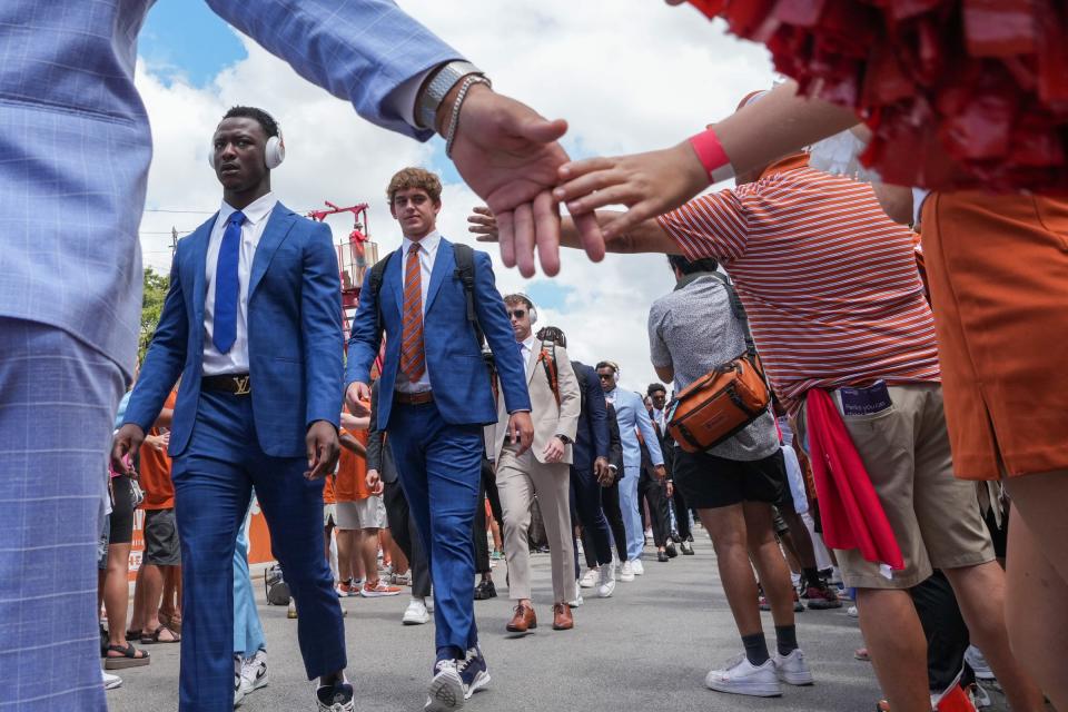 Arch Manning and fellow Texas Longhorns players greet fans before the Texas Longhorns take on Colorado State at Darrell K Royal-Texas Memorial Stadium in Austin Saturday, Aug. 31, 2024.