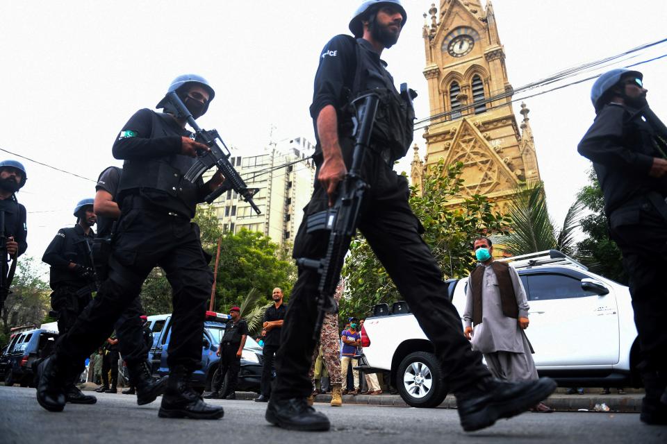 Police commandos patrol near the Pakistan Stock Exchange building following an attack by gunmen in Karachi on June 29, 2020. - At least six people were killed when gunmen attacked the Pakistan Stock Exchange in Karachi on June 9, with a policeman among the dead after the assailants opened fire and hurled a grenade at the trading floor, authorities said. (Photo by Asif HASSAN / AFP) (Photo by ASIF HASSAN/AFP via Getty Images)