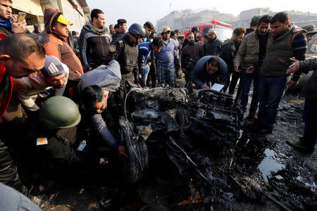 People inspect the site of a car bomb attack at a vegetable market in eastern Baghdad, Iraq January 8, 2017. REUTERS/Wissm al-Okili