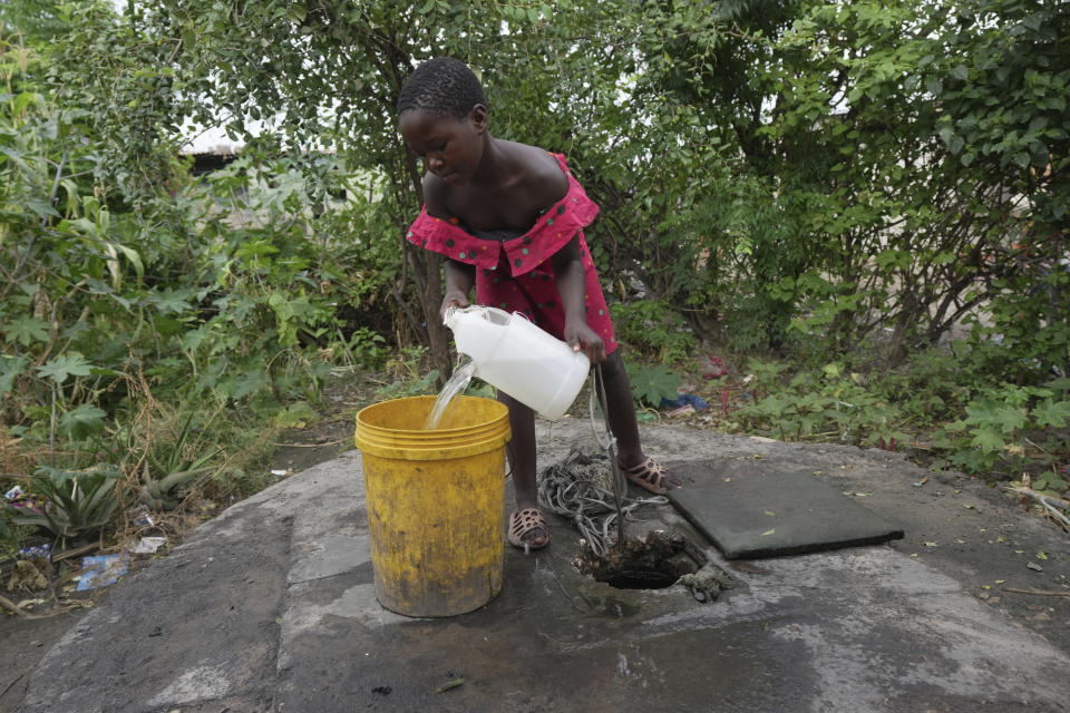 A young girl fetches water from a well in Lilanda township in Lusaka, Zambia, Saturday March 9, 2024. Lilanda, an impoverished township on the edge of the Zambian capital of Lusaka, is a typical cholera hotspot. Stagnant pools of water dot the dirt roads. Clean water is gold dust. Extreme weather events have hit parts of Africa relentlessly in the last three years, with tropical storms, floods and drought causing crises of famine and displacement, and leaving another deadly threat in their aftermath: some of the continent's worst outbreaks of cholera. (AP Photo/Tsvangirayi Mukwazhi)