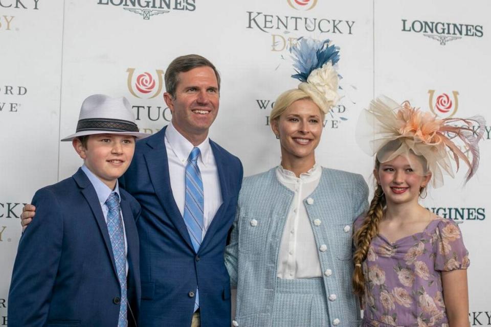 Kentucky Governor Andy Beshear and his family walk the red carpet at Churchill Downs in Louisville, Ky., Saturday, May 7, 2022.