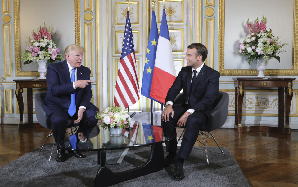 U.S President Donald Trump, left, talks to French President Emmanuel Macron during a meeting at the Prefecture of Caen, Normandy, France, Thursday, June 6, 2019. World leaders are gathered Thursday in France to mark the 75th anniversary of the D-Day landings. (Ludovic Marin/POOL via AP)