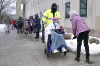 People wait on line outside a regional COVID-19 vaccination site, Monday, Feb. 1, 2021, in Wakefield, Mass. (AP Photo/Elise Amendola)