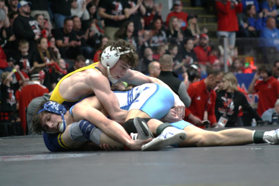 Hartland's Easton Culver, left, battles Novi Detroit Catholic Central's Mason Stewart in the 144-pound division of the MHSAA individual wrestling finals on Saturday, Feb. 24, 2024, in Kalamazoo.