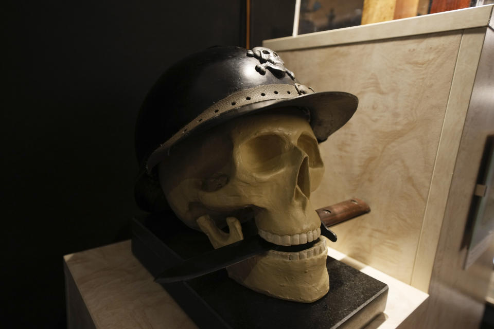 A marble skull with a knife is displayed during an exhibit titled "100 years of history between revolutions and counter revolutions" inaugurated on the occasion of the 100th anniversary of the march on Rome by Fascist Dictator Benito Mussolini, in Predappio, Friday, Oct. 28, 2022. (AP Photo/Luca Bruno)
