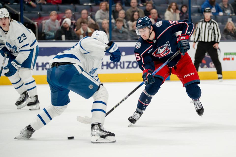 Dec 23, 2023; Columbus, Ohio, USA;
Columbus Blue Jackets defenseman David Jiricek (55) passes the puck past Toronto Maple Leafs center Calle Jarnkrok (19) during the third period of their game on Saturday, Dec. 23, 2023 at Nationwide Arena.