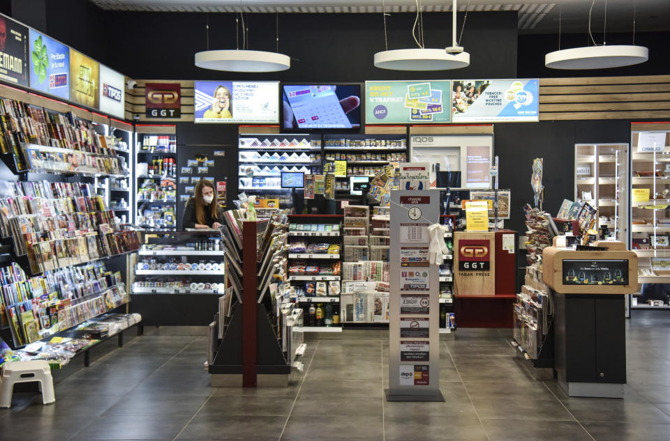 A newsagents open for customers at a shopping center in Bratislava, Slovakia, Thursday, Nov. 25, 2021. The Slovak government approved a two-week national lockdown amid a record surge of coronavirus infections. Prime Minister Eduard Heger said the measures, effective from Thursday, will target all, both unvaccinated and vaccinated. (Pavol Zachar/TASR via AP)
