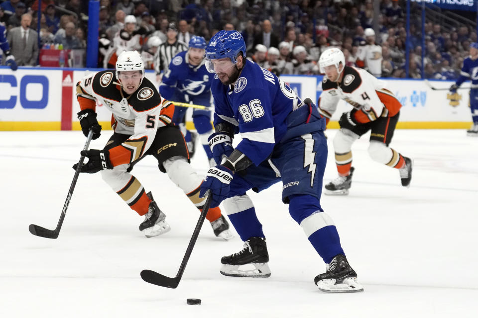 Tampa Bay Lightning right wing Nikita Kucherov (86) gets behind Anaheim Ducks defenseman Urho Vaakanainen (5) and defenseman Cam Fowler (4) during the second period of an NHL hockey game Saturday, Jan. 13, 2024, in Tampa, Fla. (AP Photo/Chris O'Meara)