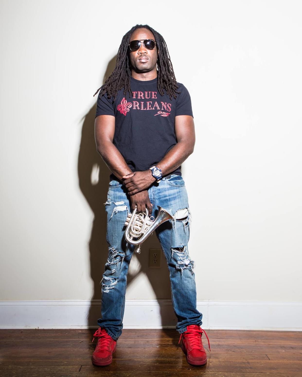 Shamarr Allen, a father in New Orleans, is offering children free trumpets in exchange for their guns. (Photo: Jon Gunnar)