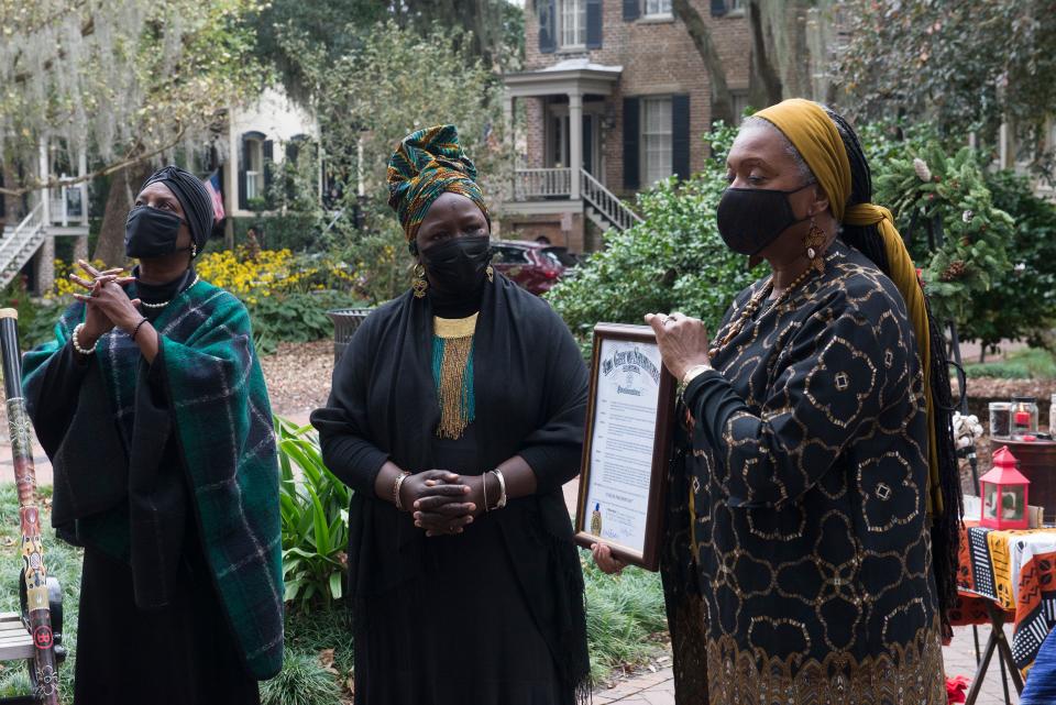 Rosalyn Rouse, left, and Patt Gunn look on as Alderwoman Bernetta Lanier reads a proclamation from the city of Savannah recognizing Jubilee Freedom Day in Calhoun Square. [Will Peebles/Savannahnow.com]