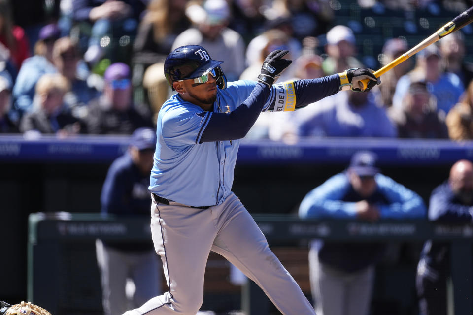 Tampa Bay Rays' Isaac Paredes follows the flight of his RBI single off Colorado Rockies pitcher Dakota Hudson in the third inning of a baseball game Sunday, April 7, 2024, in Denver. (AP Photo/David Zalubowski)