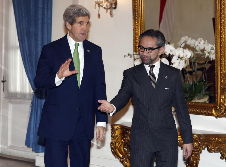 U.S. Secretary of State John Kerry, left, is ushered by Indonesian Foreign Minister Marty Natalegawa before a meeting at the Foreign Ministry office in Jakarta, Indonesia, Monday, Feb. 17, 2014. (AP Photo/Adi Weda, Pool)
