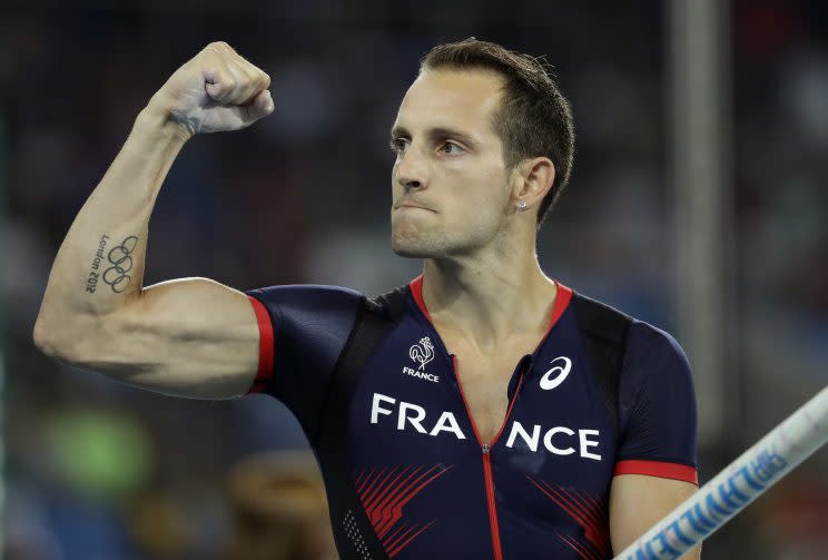 France's Renaud Lavillenie celebrates after an attempt in the men's pole vault final. (AP)