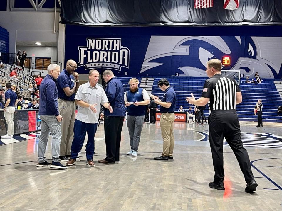 University of North Florida coach Matthew Driscoll makes his case with an official during Saturday's 90-85 overtime victory over Auston Peay.