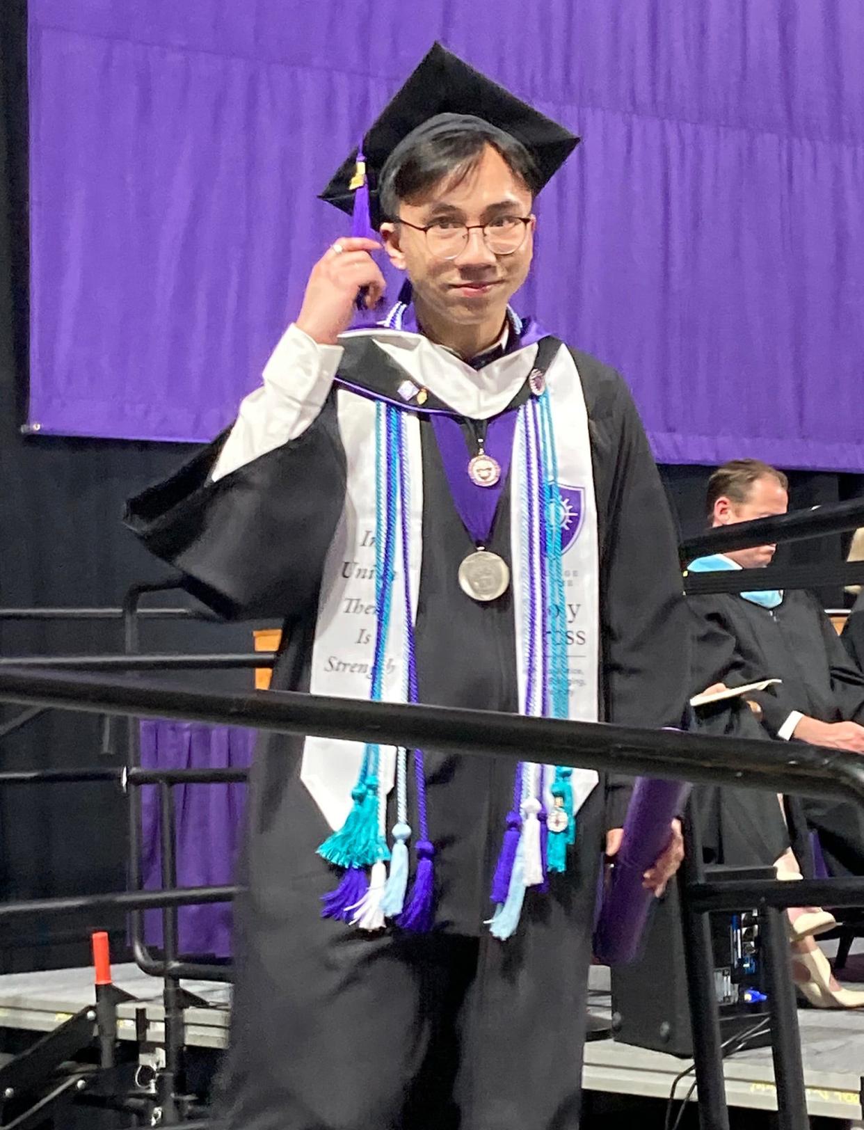 Graduate Anhthi Phan steps off the stage after receiving his degree during College of the Holy Cross commencement at the DCU Center Friday.