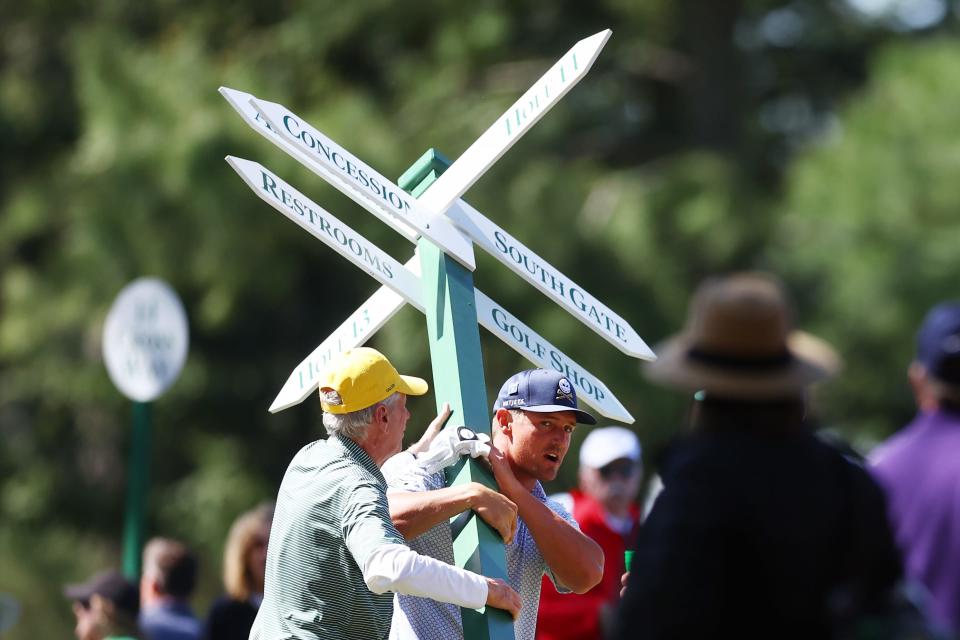 Bryson DeChambeau earned a piece of the Masters lead and helped volunteers replace a sing at the 14th fairway during Friday's second round.