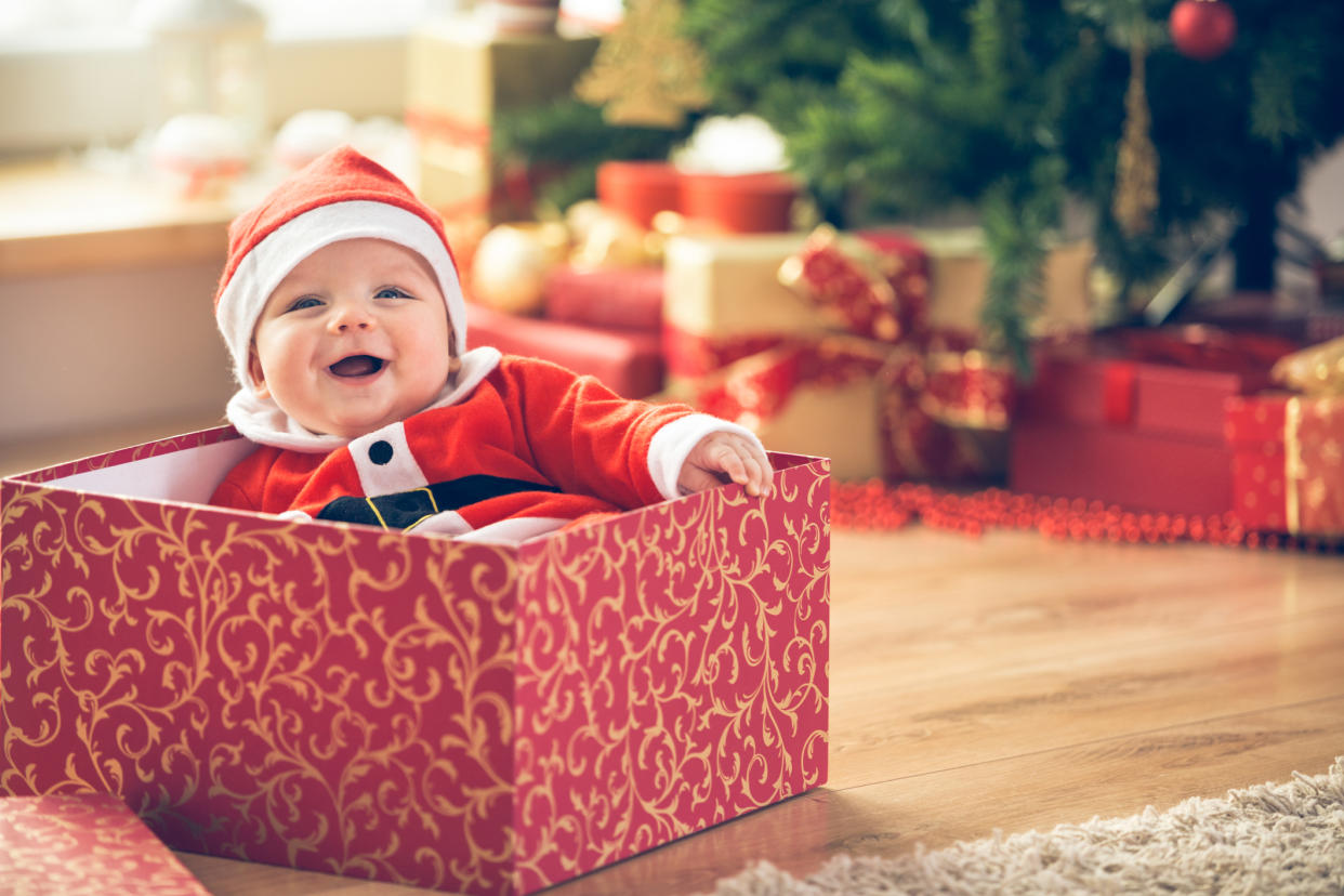 Photo of a baby in a Christmas present box to illustrate a list of Christmas baby names. (Getty Images)