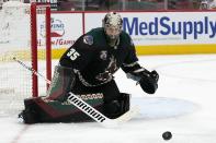 Arizona Coyotes goaltender Darcy Kuemper makes a save against the Minnesota Wild during the second period of an NHL hockey game Wednesday, April 21, 2021, in Glendale, Ariz. (AP Photo/Ross D. Franklin)