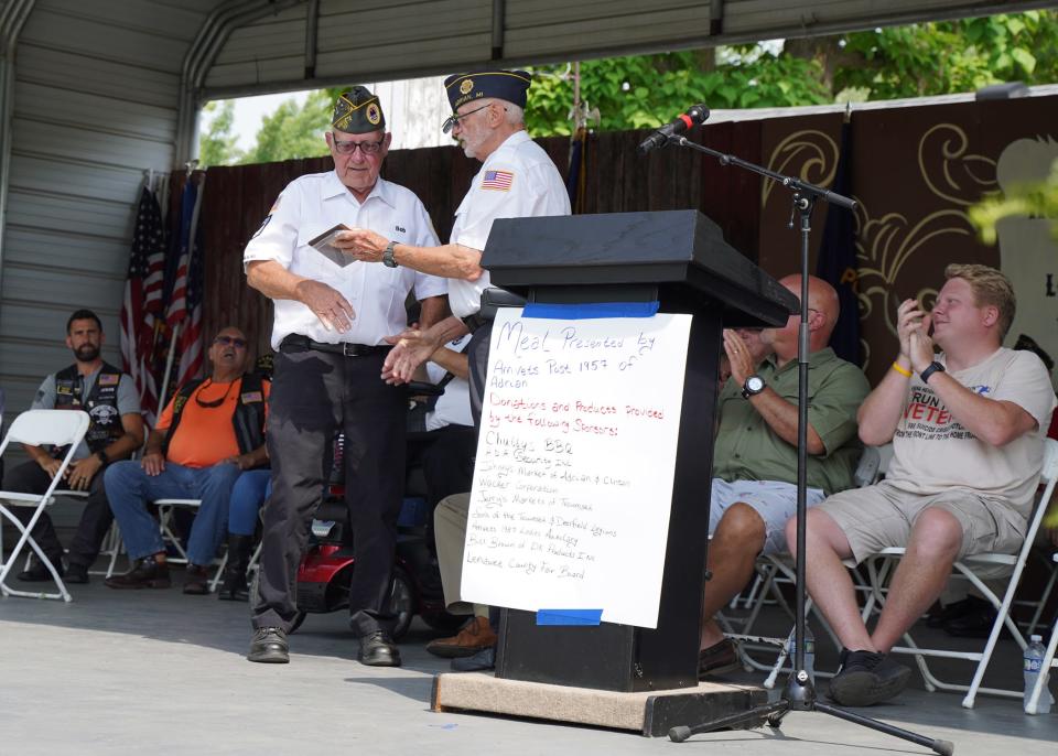 Dave Loop of American Legion Post 97 presents Robert Whipple, a member of many veterans organizations, with the award for Veteran of the Year runner-up during the Veterans Day program Wednesday at the Lenawee County Fair.