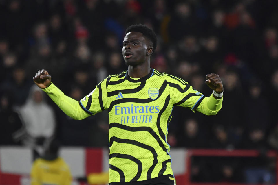 Arsenal's Bukayo Saka celebrates after scoring his side's second goal during the English Premier League soccer match between Nottingham Forest and Arsenal at the City Ground stadium in Nottingham, England, Tuesday, Jan. 30, 2024. (AP Photo/Rui Vieira)