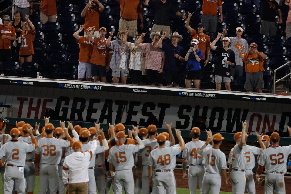 Texas players celebrate with their fans after beating Virginia during last year's College World Series. The Longhorns are making their 38th trip to Omaha this week and open their CWS on Friday against Notre Dame.