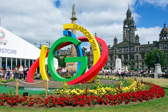 Glasgow 2014 XX Commonwealth Games brand logo in George Square Glasgow with Superstore left and Glasgow City Council building