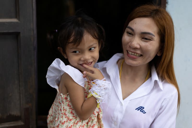 Panompai Sithong holds her daugther Paveenut Supolwong, the only child survivor of the mass shooting in Uthai Sawan