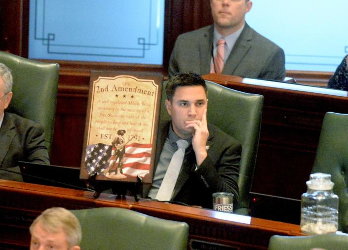 State Rep. Adam Niemerg, R-Teutopolis, put a Second Amendment sign in front of him during the debate on House Bill 5471 on the House floor Tuesday.