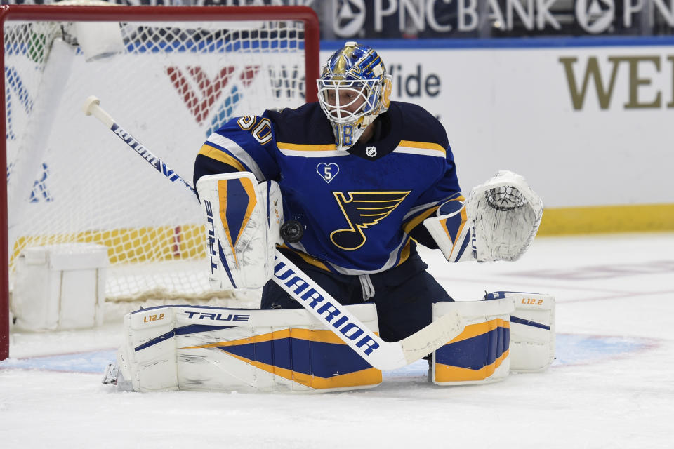 St. Louis Blues' Jordan Binnington blocks a shot from the Anaheim Ducks during the first period of an NHL hockey game Friday, March 26, 2021, in St. Louis. (AP Photo/Joe Puetz)