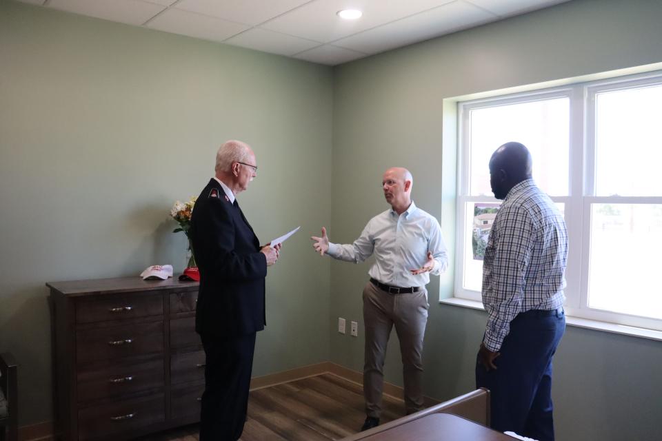 Nick Browning (center), Mahoning/Akron/Canton president for Huntington Bank and one of the co-founders of Grace House Akron, discusses the free hospice care for those who need it, with Salvation Army Acting Area Coordinator Lt. Col. Jim Reynolds (left) and Anthony Burwelll, a Summa chaplain.