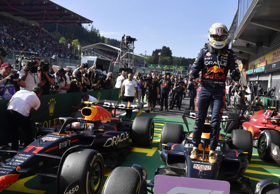 Red Bull driver Max Verstappen of the Netherlands stands on his car in the Parc Ferme after winning the Formula One Grand Prix at the Spa-Francorchamps racetrack in Spa, Belgium, Sunday, Aug. 28, 2022. (AP Photo/Geert Vanden Wijngaert, Pool)