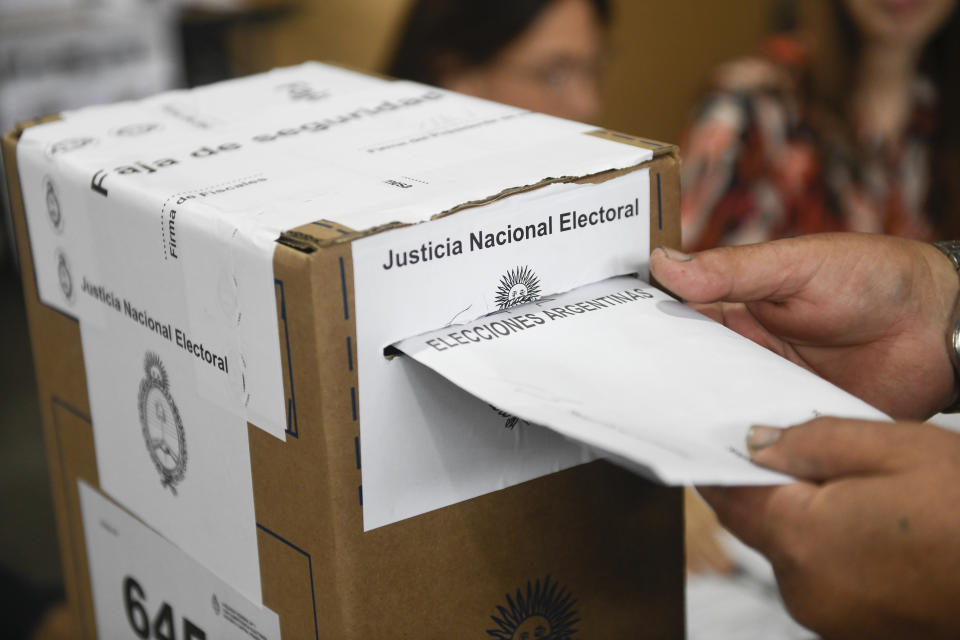 A voter casts her ballot during general elections in Buenos Aires, Argentina, Sunday, Oct. 22, 2023. (AP Photo/Gustavo Garello)
