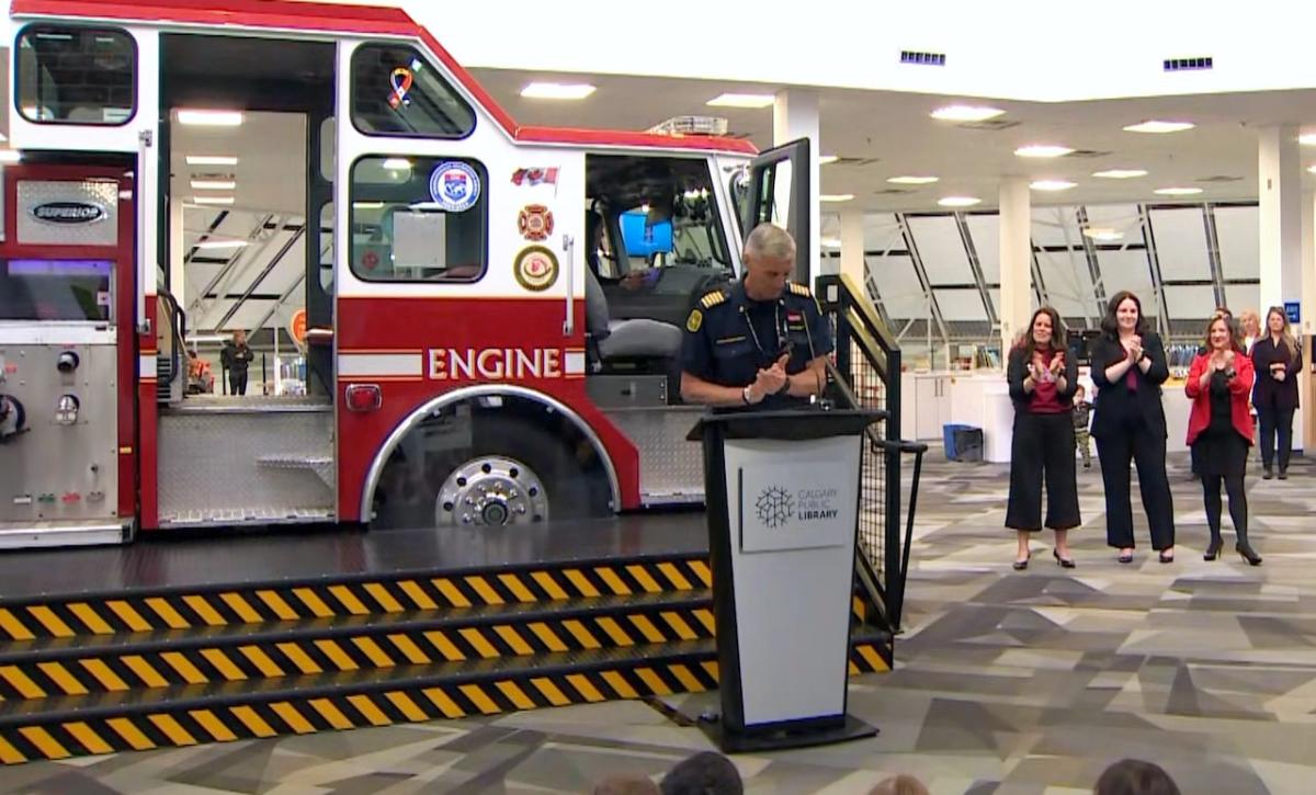 A large red fire truck stands in a library in Calgary and is open to visitors