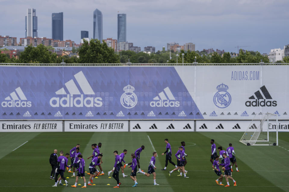 Real Madrid players warm up during a training session in Madrid, Tuesday, May 23, 2023. Spanish police say four people suspected of hanging an effigy of Real Madrid player Vinícius Júnior off a highway bridge in Madrid in January have been arrested. The arrests come two days after the latest case of racial abuse against the Brazil forward in a Spanish league game against Valencia. (AP Photo/Bernat Armangue)