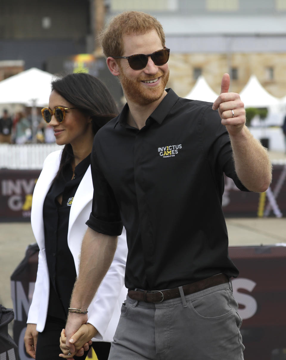 Britain's Prince Harry gestures as he and Meghan, Duchess of Sussex visit the Invictus Games driving challenge on Cockatoo Island in Sydney, Australia, Saturday, Oct. 20, 2018. Prince Harry and his wife Meghan are on day five of their 16-day tour of Australia and the South Pacific. (AP Photo/Kirsty Wigglesworth)