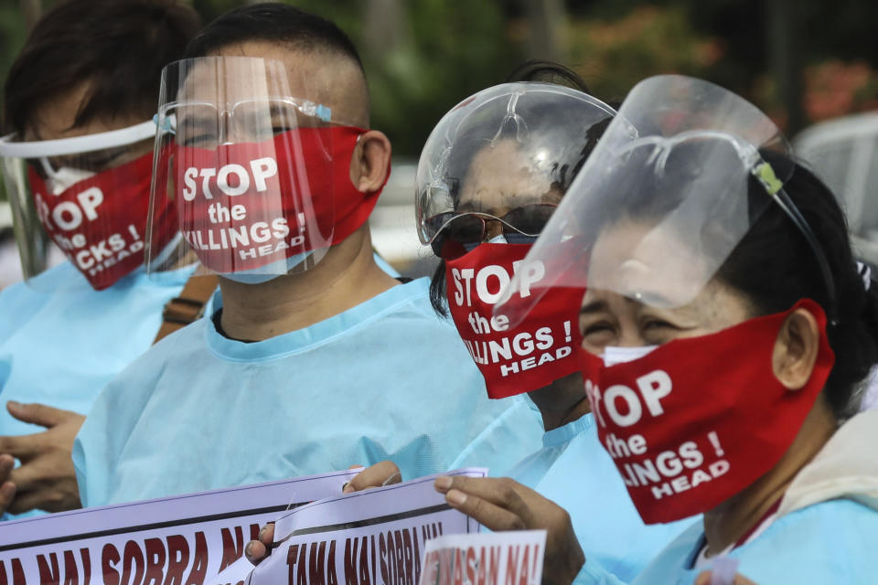 Protesters wear face masks with slogans before marching towards the House of Representative where Philippine President Rodrigo Duterte is set to deliver his final State of the Nation Address in Quezon city, Philippines on Monday, July 26, 2021. Duterte is winding down his six-year term amid a raging pandemic and a battered economy. (AP Photo/Gerard Carreon)