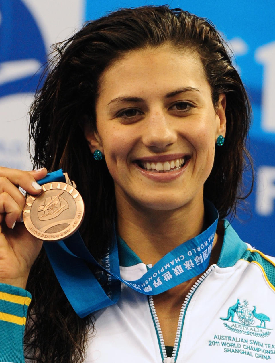 Australia's bronze medalist Stephanie Rice celebrates on the podium during the award ceremony for the final of the women's 400-meter individual medley swimming event in the FINA World Championships at the indoor stadium of the Oriental Sports Center in Shanghai on July 31, 2011. (MARK RALSTON/AFP/Getty Images)