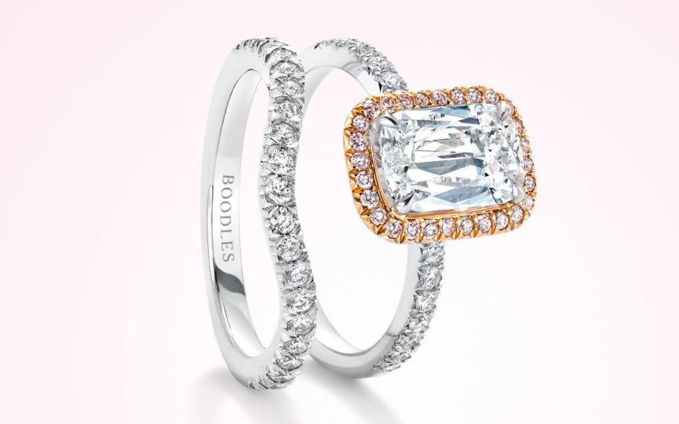 Boodles' vintage shaped half-hoop wedding band is curved to accommodate a large central stone, such as the Ashoka-cut diamond seen in this engagement ring