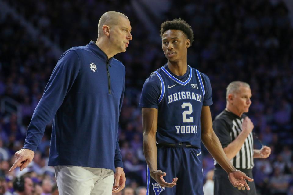 Feb 24, 2024; Manhattan, Kansas, USA; Brigham Young Cougars head coach Mark Pope talks to guard Jaxson Robinson (2) during a break in first-half action against the Kansas State Wildcats at Bramlage Coliseum. Mandatory Credit: Scott Sewell-USA TODAY Sports