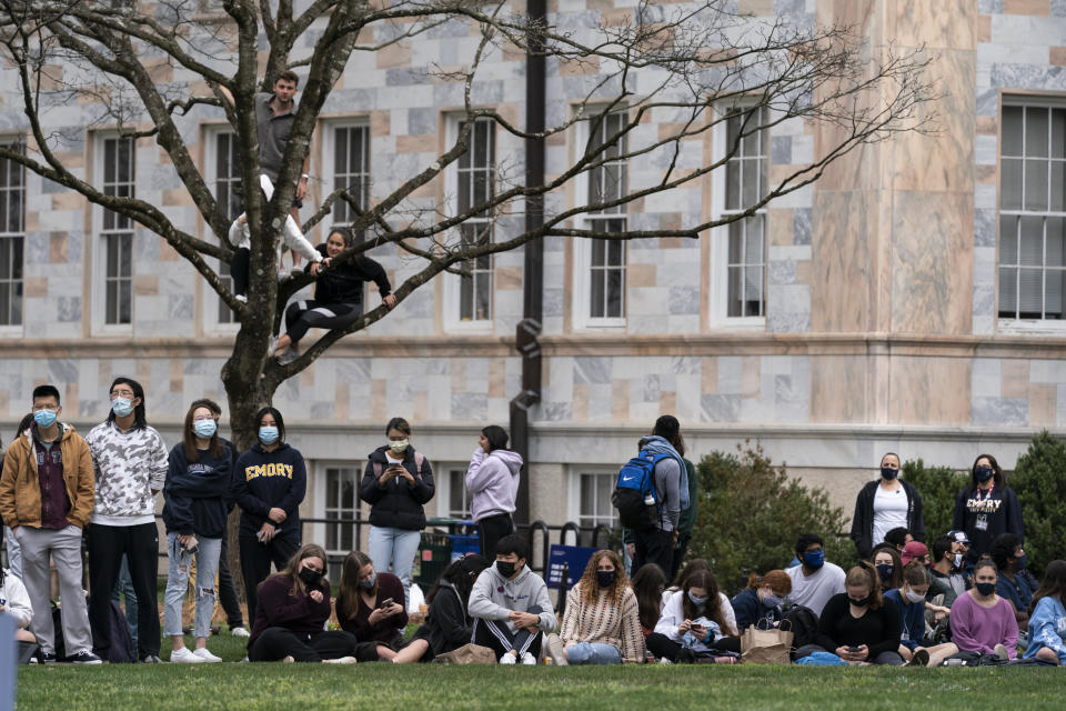 Students and other bystanders gather in the Quad as President Joe Biden and Vice President Kamala Harris hold an event in a nearby building at Emory University, Friday, March 19, 2021, in Atlanta. (AP Photo/Alex Brandon)