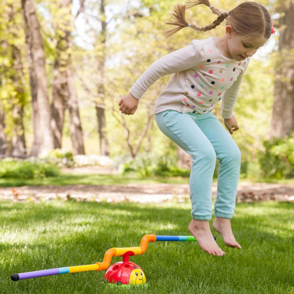 girl jumping in grass