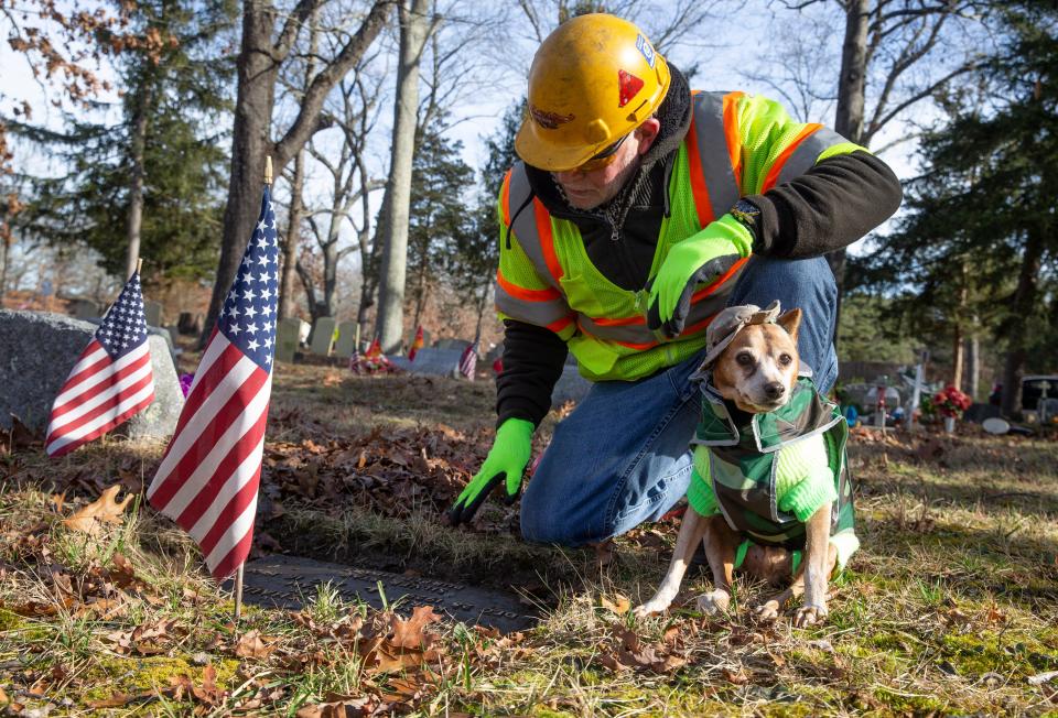 Peter Sztybel and his dog Whiskey, a 16-year-old Red Miniature Pinscher, seek out hidden, overgrown graves of military veterans and spruce them up. They are working in the Whiting Cemetery on this particular day.   Manchester, NJWednesday, January 12, 2022 