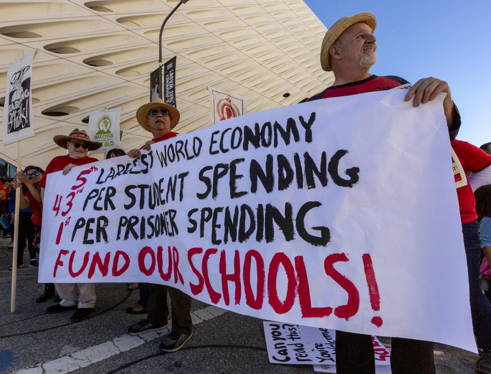 In this Saturday, Dec. 15, 2018, photo, thousands of teachers rally outside The Broad, a contemporary art museum downtown Los Angeles. Teachers in the nation's second-largest school district will go on strike next month if there's no settlement of its long-running contract dispute, union leaders said Wednesday, Dec. 19. The announcement by United Teachers Los Angeles threatens the first strike against the Los Angeles Unified School District in nearly 30 years and follows about 20 months of negotiations. (AP Photo/Damian Dovarganes)