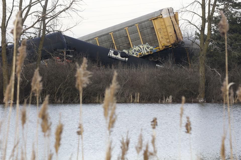 Multiple cars of a Norfolk Southern cargo train lie toppled on one another after derailing at a train crossing with Ohio 41 in Clark County, Ohio, Saturday, March 4, 2023. (Bill Lackey/Springfield-News Sun via AP)